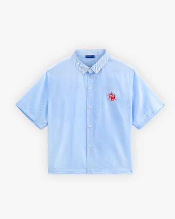 Light blue checkered shirt with a red logo on a white background