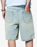 Light blue denim shorts worn by a person on a white background